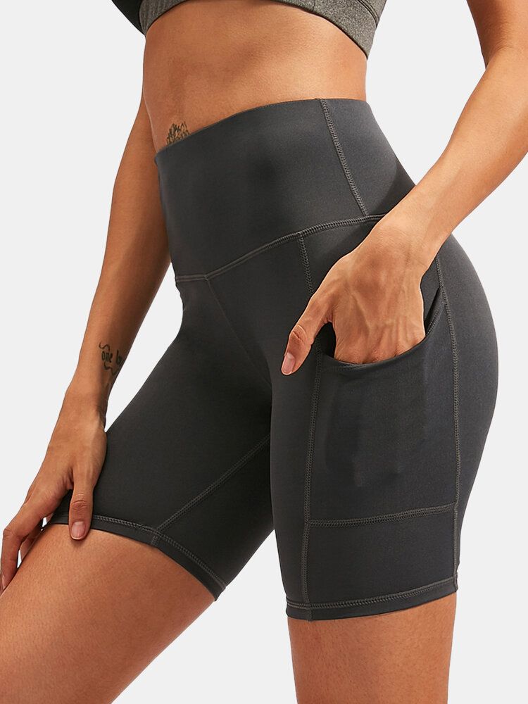 Short De Sport De Yoga À Séchage Rapide De Couleur Unie Pour Femmes Avec Poche Latérale